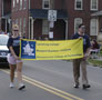 Students carry College Town banner