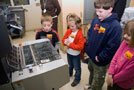Youngsters watch an offset duplicator in action