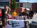 Phi Mu Delta's Sam M. Schulte enjoys a hot dog in foreground, joined by, from left rear, Lucas J. Gilson (also Phi Mu Delta), and (from Sigma Pi) Tyler J. Harry, Andrew L. Palmer, Patrick D. Smith, Robert J. Conrad and Shane R. Miller