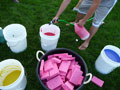 Kids' washable paint is watered down in 5-gallon buckets for 'Color Wars'