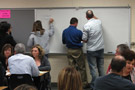Attendees engage in breakout discussions, whiteboard activities