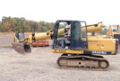 Tyler A. Davis, a heavy construction equipment technology: operator emphasis major from Beavertown, demonstrates an excavator ...