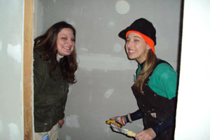 Ashley M. Stuck and Patricia A. Hintz drywall a closet in Yonkers, N.Y., with Habitat for Humanity of Westchester County.