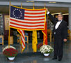Theodore J. Szuhaj displays flag for attendees