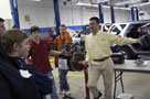 Joseph A. Tavani, industry/internship specialist for the School of Transportation Technology, enlightens visitors to the Honda lab