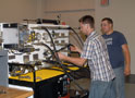 Students perform an exercise at a hydraulics training station in CAL