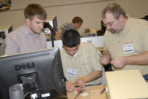 Students from DeVry University ponder the newly unveiled mystery project during a %E2%80%9Cbrown bag%E2%80%9D competition, designed by Pennsylvania College of Technology students.