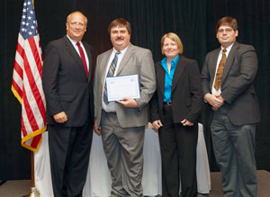 Acknowledging Pennsylvania College of Technology%E2%80%99s certification in June are, from left, David M. Wennergren, deputy assistant secretary of defense for information management and technology%2Fdeputy chief information officer%3B  and Penn College faculty members Jacob R. Miller, associate professor of computer science%3B Sandra Gorka, assistant professor of computer science%3B and Daniel W. Yoas, assistant professor of computer information technology.