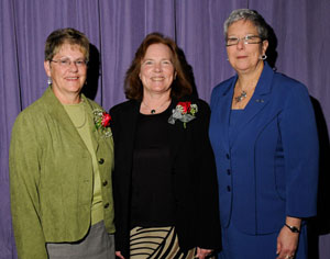 Joan McFadden is flanked by her nominator, Arlene Deppen, and President Gilmour.