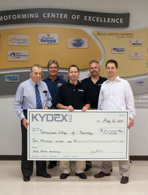 From left, C. Hank White, director of the Plastics Manufacturing Center at Pennsylvania College of Technology, and Timothy E. Weston, associate professor of plastics technology at the college, accept a check from KYDEX, LLC representatives Jim Medalie, president%3B Tom Kapelewski, manufacturing manager%3B and Bryan Ciesielski, quality manager, as KYDEX becomes a Gold Charter Member of the college%E2%80%99s Thermoforming Center of Excellence.