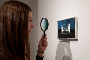 Rebecca R. Miller, a graphic communications management student from Williamsport, looks at 'M.C. Carlos %E2%80%93 360,'a photograph made by Larry Erb, of Alto, Ga., using a pinhole camera. The photo placed first in The Gallery at Penn College%E2%80%99s juried alumni art exhibit, 'Kaleidoscope.'