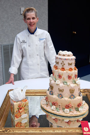 Kelly E. Rockwell, of Trout Run, with her cake, which was honored recently in the Cake Decorating Extravaganza, a competition held as part of the Atlantic Bakery Expo.
