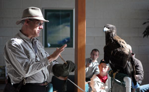 Forest technology student Michael C. Frantz, of Loganton, snaps a cell-phone photo of Michael W. Kuriga and his winged guest.