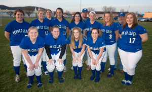 The 2009 Lady Wildcat softball team gathers with its coaches for a group photo.