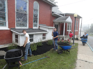 Jeremy E. Wilson, of Lock Haven (left foreground), and Tyler D. Gerz, of Lancaster (in blue shirt), both enrolled in the landscape%2Fhorticulture technology%3A landscape emphasis major at Pennsylvania College of Technology, join their classmates in a community-service project at First United Methodist Church in Montgomery.