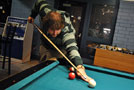 Sigma Nu Vice President Drew Koskie lines up a shot in the CC Game Room