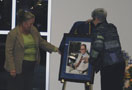 Darla Logue and college President Davie Jane Gilmour unveil a memorial portrait