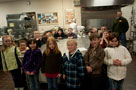 A group gathers for a photo after making pretzels in a baking/pastry arts lab