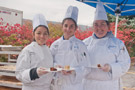 Offering samples of three seasonal cakes are, from left, culinary arts technology majors Antonia Castaneda, Avondale, and Katrina N. Grado, Williamsport; and Christine M. Reed, a culinary arts and systems student from Kingston