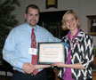 Primus Technologies Corp.'s Keith Boyer receives a plaque from Elizabeth A. Biddle, K-12 project manager, in appreciation of the business's participation