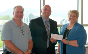 Ryan A. English, area manager for J-W Measurement Co., presents a check to Debra M. Miller, director of corporate relations, and William E. Mack, assistant dean of industrial and engineering technologies, for the establishment of the Marcellus Measurement Scholarship Fund at Pennsylvania College of Technology.