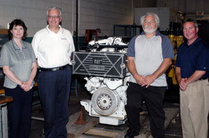 Surrounding a Caterpillar C32 marine engine recently donated to Pennsylvania College of Technology are, from left, Mary A. Sullivan, dean of natural resources management%3B Ron Garber, of Ransome CAT, Bensalem%3B Francis Campbell, of Ransome Engine, Hammonton, N.J.%3B and Brett A. Reasner, assistant dean of natural resources management.