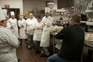 Tasting judge Christopher R. Grove, '08, of the Williamsport Country Club, talks with students about their dishes