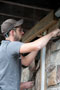 Corvin K. Oberholtzer, of Wellsboro, uses a slicker tool to compress the mortar and assure a tight fit once the stone has been bedded into place