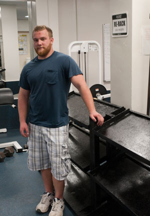 Matthew C. Kline, a welding engineering technology student from Whitehall, with the weight racks he designed and fabricated for the fitness laboratory at Pennsylvania College of Technology.