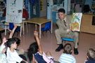 Children gather around the mayor to hear 'Up, Down and Around' 