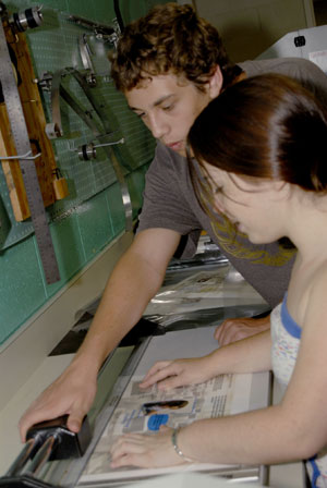Media Arts Summer Exposure participants trim one of several printed projects they created.