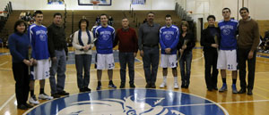 Wildcat cagers Phillip Kaylor (22), Jordan McBeth (23), Nico Italiani (14) and Greg Solyak (21) line up with their parents for a senior tribute at half-court 