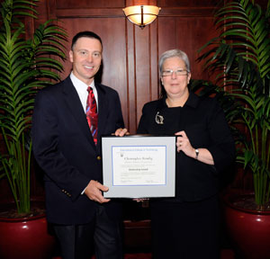Christopher Kendig, district sales manager for Komori America Corp., accepts the 2009 Mentorship Award from Pennsylvania College of Technology President Davie Jane Gilmour.