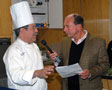 Chef Michael J. Ditchfield explains the ground rules to emcee Gary Chrisman