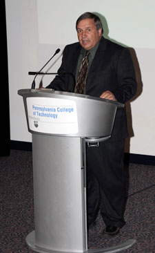 Retiring as Penn College's director of athletics, Michael J. Stanzione addresses an audience in the Student and Administrative Services Center.