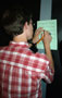 A student signs a classmate's 'Bingo' card