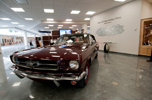 A 1965 Ford Mustang restored by Pennsylvania College of Technology students and honored at a recent Antique Automobile Club of America meet, is maneuvered into the Madigan Library for display at the college%E2%80%99s Oct. 23 Open House. (Photo by Whitnie-Rae Mays, student photographer)