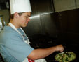 A North Penn student sautes vegetables in a School of Hospitality kitchen