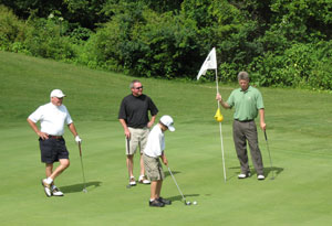 Three generations of the Reasner family - from left, Bill, Brett (assistant dean of natural resources management at Penn College) and Connor - form a foursome with teammate John Engel.