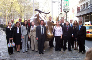 Roy A. Fletcher, assistant professor of business administration%2Fbanking and finance (center), gathers with Pennsylvania College of Technology students around the 'Charging Bull' landmark in New York City%E2%80%99s Financial District.
