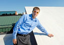 Alumnus Nathaniel L. Baum shows off an energy-efficient roof coating at Susquehanna Bancshares Inc.'s headquarters in Litiz, where he is facility supervisor (Photo by Jeff Ruppenthal, Sunday News)