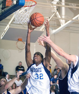 The Wildcats' Neil Baskerville pulls down a rebound during Friday's action in Bardo Gym.