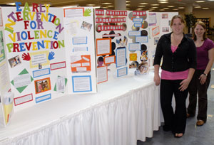 Occupational therapy assistant students Joleene M. Oyster, left, of Winfield, and Michelle B. Rabenstein, of Altoona, display some of the educational posters to be presented April 30 in Pennsylvania College of Technology%E2%80%99s Madigan Library.