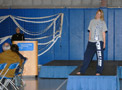 Nicole M. Krater, a health arts: practical nursing emphasis major from Altoona (and member of the Wildcat Dance Team) models Penn College clothing during a kickoff brunch/fashion show in the Field House presided over by President Davie Jane Gilmour (at podium)