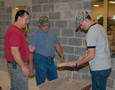 David D. Peiffer, a building construction technology student from Bernville, joins father Dean A. and Glenn R. Luse, instructor of building construction (left), at a 'Designing With Stone Veneer' workshop in the college's new Construction Masonry Building