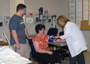 Nursing instructor Tonja R. Pennycoff conducts a free blood-pressure screening for Lisa Weaver, of Hanover, accompanied by son Justin W., a technology management major and Student Ambassador