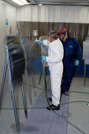 ... and, in the well-appointed College Avenue Labs, trains a vocational instructor on use of waterborne auto-body finishes.