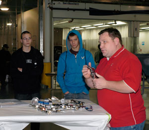 Jim Kvatek, supervising instructor at the PPG Pittsburgh Business Development Center, discusses spray-gun nozzles with Penn College students ...
