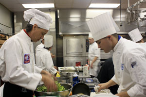Pennsylvania College of Technology culinary arts and systems student Brian M. Toomey, of Danville, left, works with Mark Pawlowski, of The Yorktowne Hotel, during the Pennsylvania Tourism and Lodging Association%E2%80%99s Pennsylvania Palate Competition.