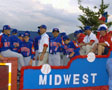 The Midwest entry (Canyon Lake Little League from Rapid City, S.D.) rides past Penn College